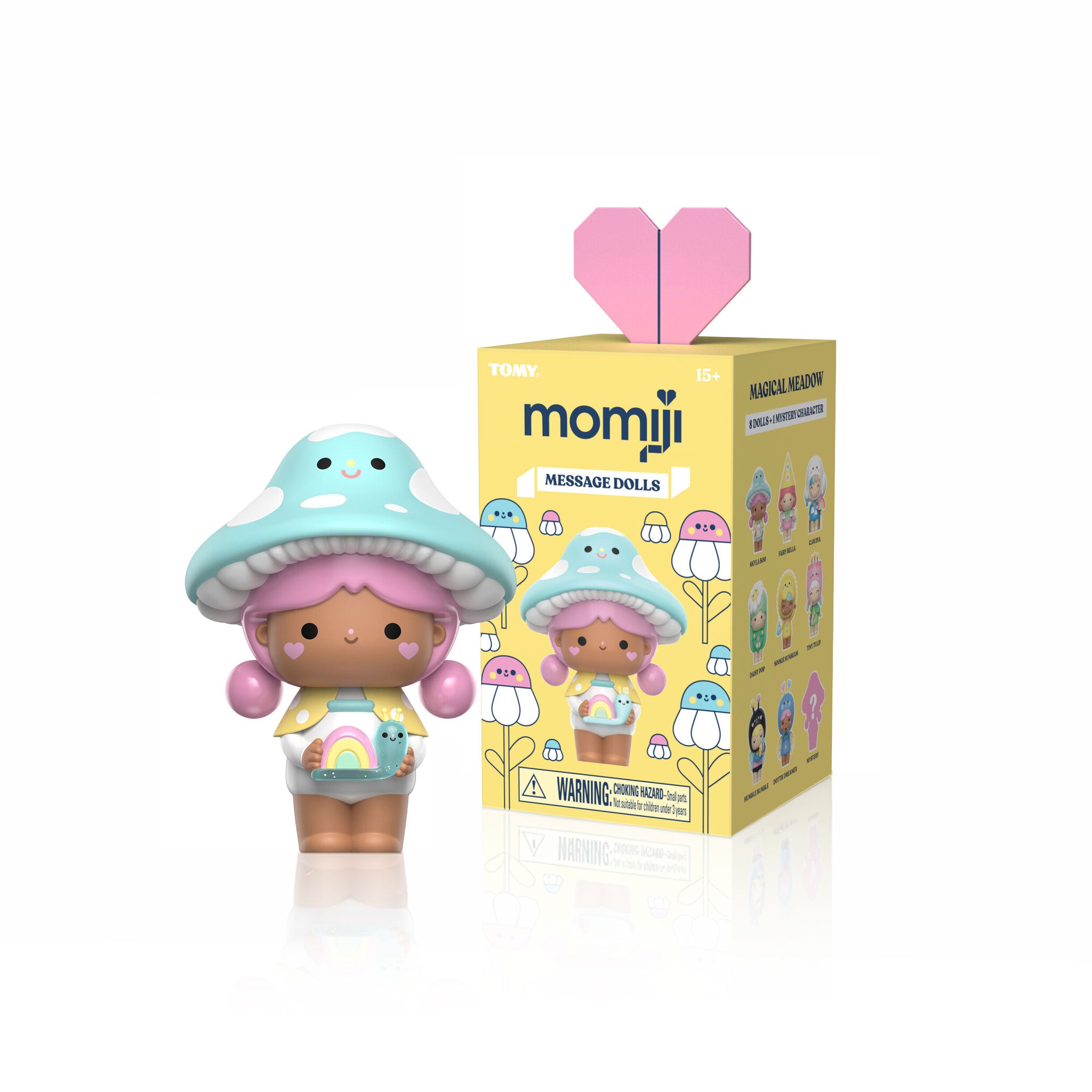 Magical Meadow Momiji doll with a blue mushroom hat stands next to a yellow box from the blind boxed set of 8. — Momiji doll