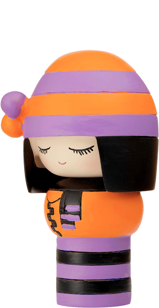 Clever Clogs Momiji doll with closed eyes, black hair, and an orange and purple striped outfit and matching hat. — Momiji doll