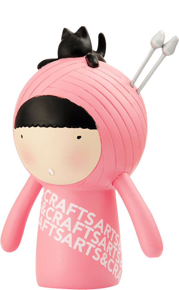 Momiji doll "Purrl" in pink, with black hair, knitting needles in its head, and a tiny black cat perched on top. — Momiji doll