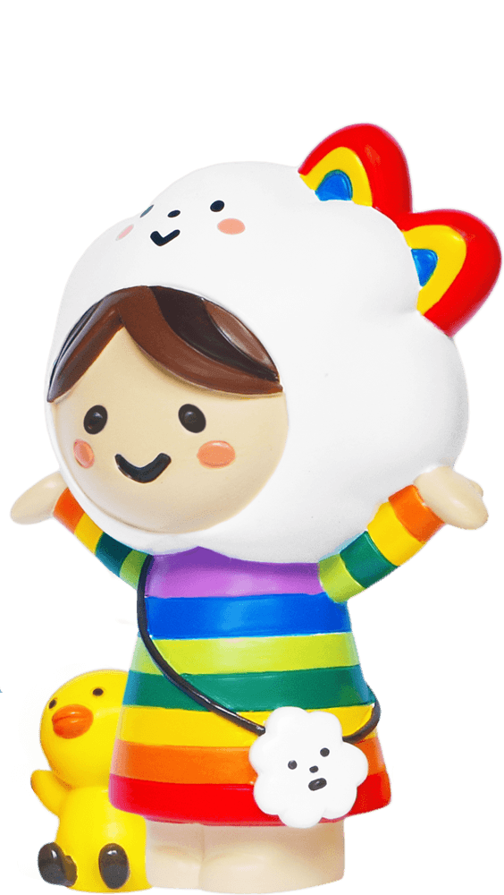 Miss Rainbow & Chicky Momiji doll in a rainbow dress with an animal hood, posed next to a small yellow duck. — Momiji doll
