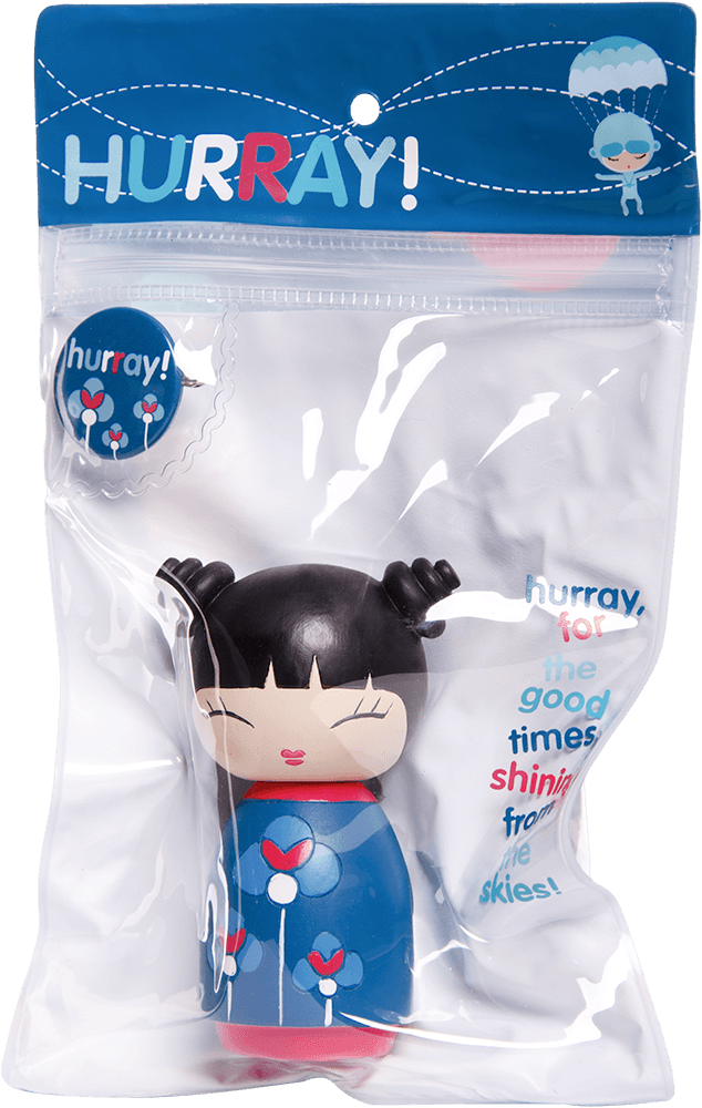 Hurray Momiji doll with black hair, blue dress, displayed in clear packaging with a colorful button on the front. — Momiji doll