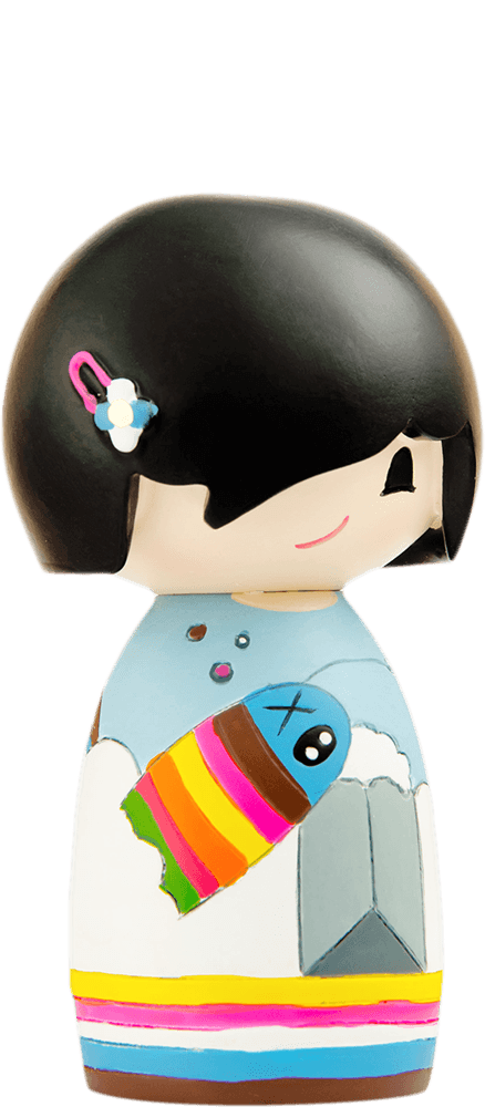 Sonny Momiji doll with black hair, blue hairclip, and a vibrant striped fish painted across its colorful body. — Momiji doll