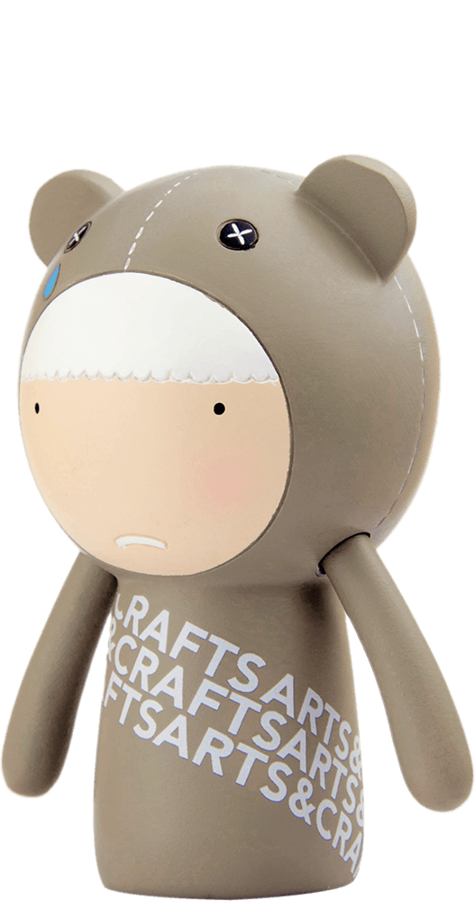 Ted Momiji doll in a brown bear suit, blue teardrop detail, “CRAFTSARTS” text; inspired by Tokyo and Seoul street style. — Momiji doll