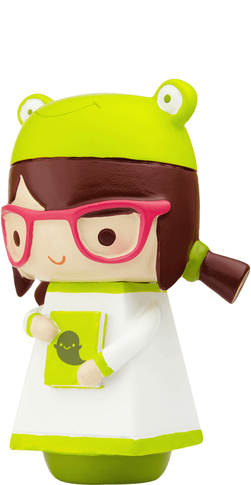 Phoebe Momiji doll with glasses, a cute frog hat, and holding a green book with a black cartoon face. — Momiji doll