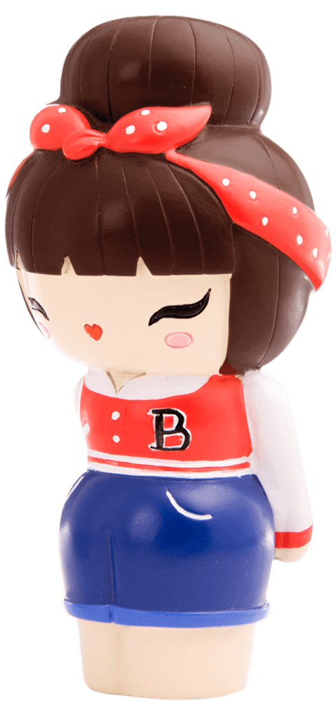 Rockabilly Momiji doll winks, smiling, with brown hair, a red polka dot headband, red "B" jacket and blue skirt. — Momiji doll
