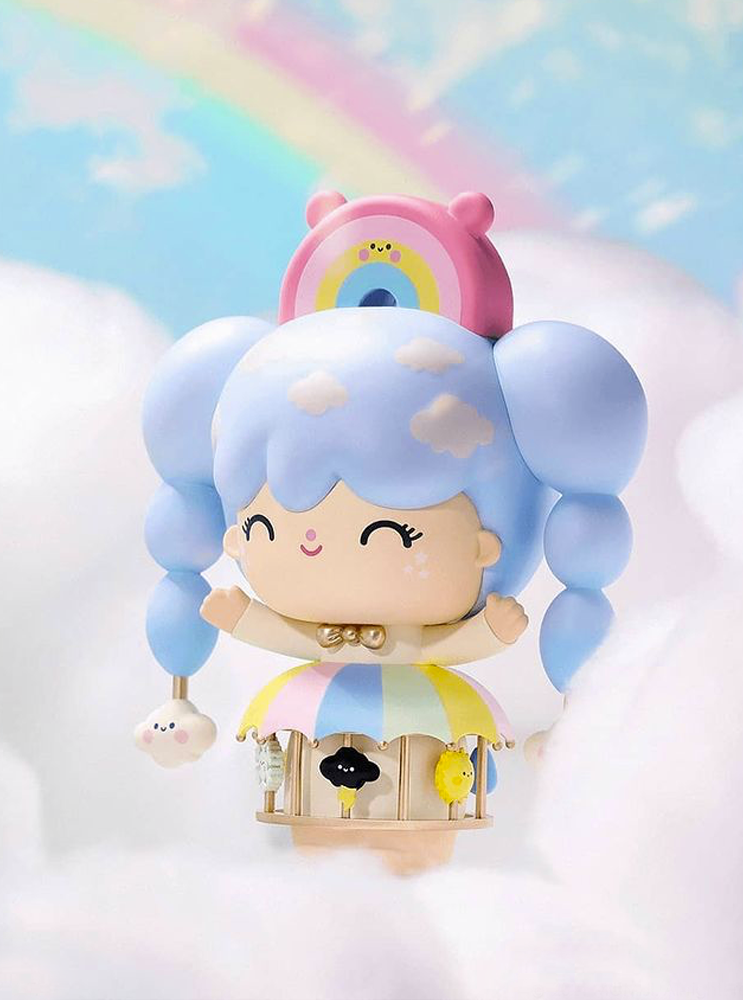 The Sky Dreamer Momiji doll with blue hair floats among clouds, a rainbow, and an umbrella in the sky. — Momiji doll